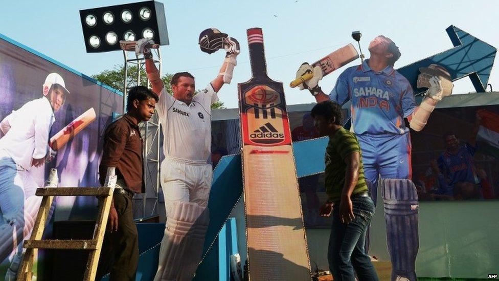 Indian workers adjust cut-outs of Sachin Tendulkar on a float made in honour of his second last Test against the West Indies in Calcutta, 3 November 2013