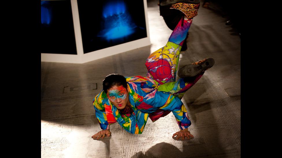 A model break dances on the catwalk during Fashion in Motion: Kansai Yamamoto at the V&A, London, 1 November 2013.