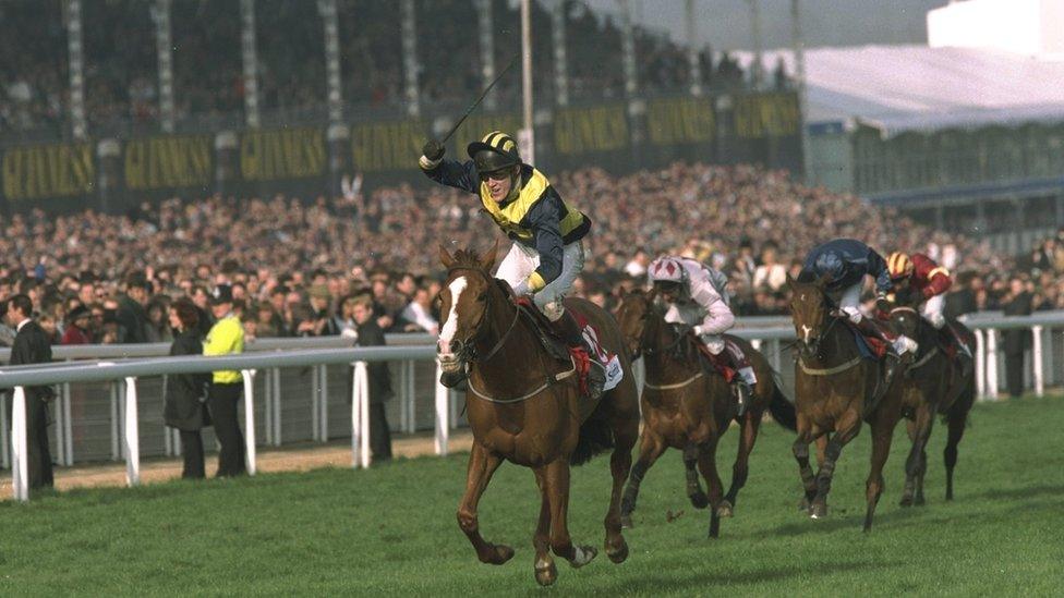 AP McCoy salutes the crowd after winning the 1997 Champion Hurdle at Cheltenham on Make A Stand