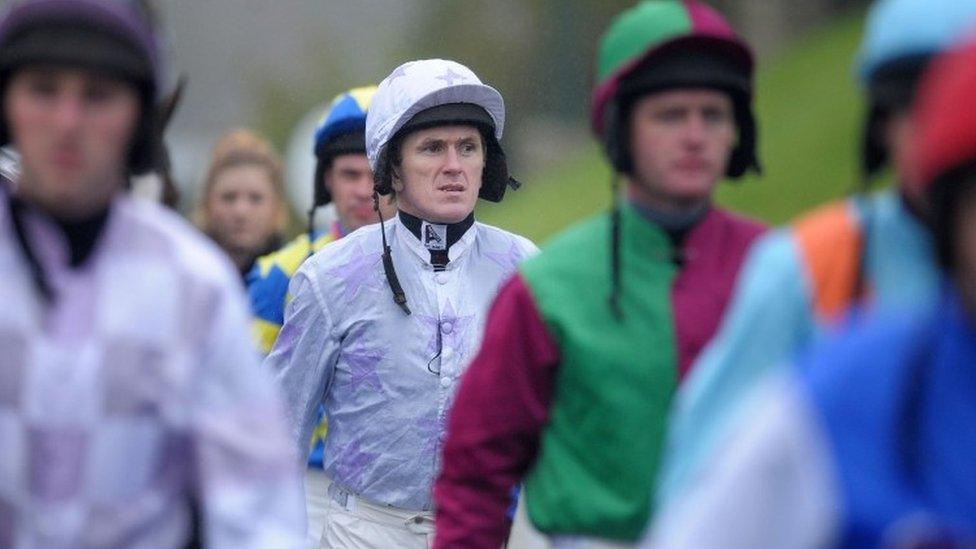 AP McCoy leaves the weighing room with colleagues ahead of a race