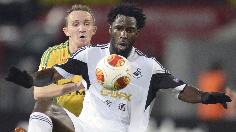 Kuban defender Aleksei Kozlov (L) challenges Swansea goal-scorer Wilfried Bony