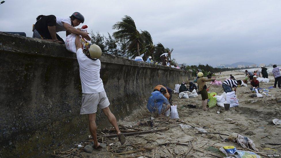 Residents in central Da Nang city, Vietnam, pack sandbags as they prepare for Typhoon Haiyan. 9 Nov 2013