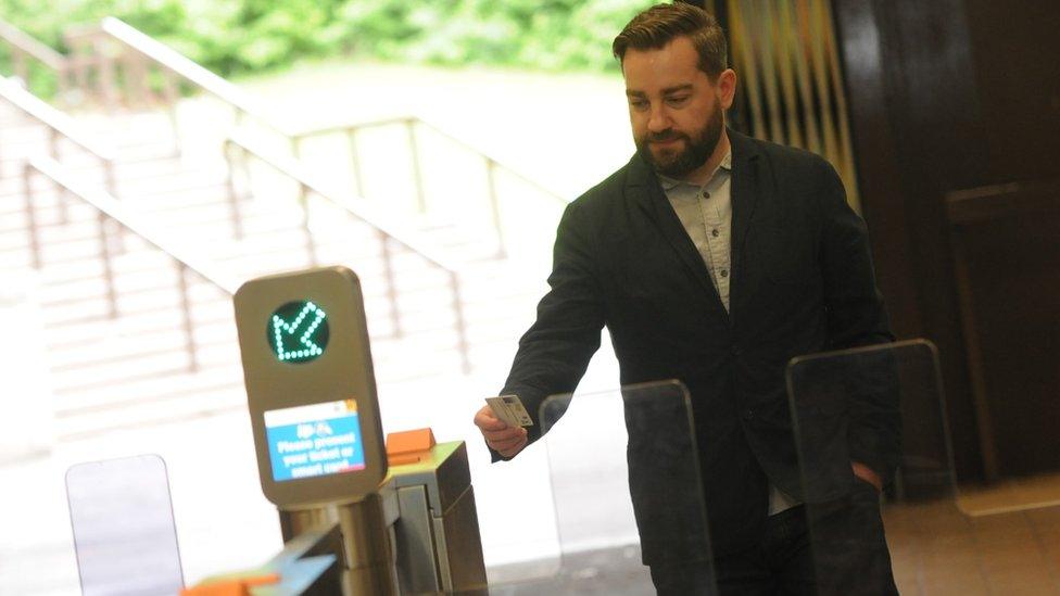 Man using automatic ticket gates