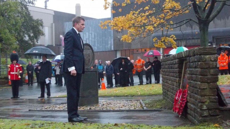Secretary of State for Wales David Jones lays a wreath at the Royal Mint"s war memorial in Llantrisant, Wales.