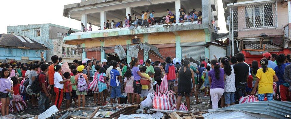 Looted goods are thrown from a warehouse in the town of Guiuan, Eastern Samar province