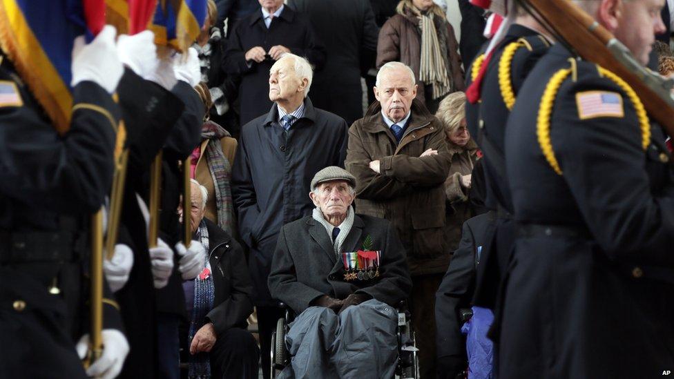 World War II veteran, Harry Marrington, centre, from Portsmouth, England, watches from his wheelchair during an Armistice Day ceremony under the Menin Gate in Ypres, Belgium