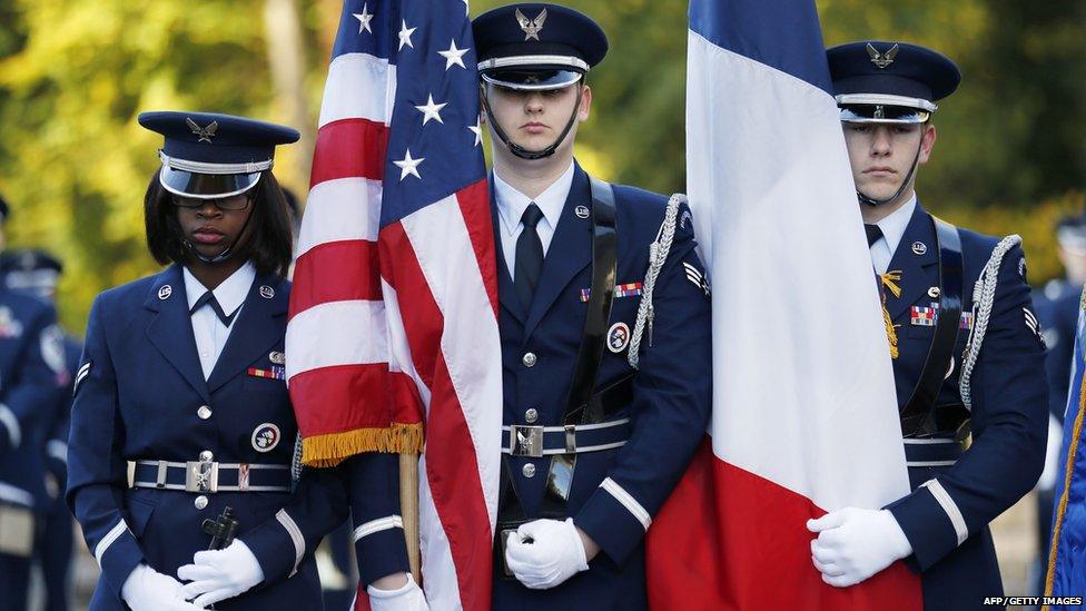 US Air Force soldiers hold French and US flags as they attend the Remembrance Day ceremony at The Lafayette Escadrille Memorial of Marnes-la-Coquette, east of Paris,