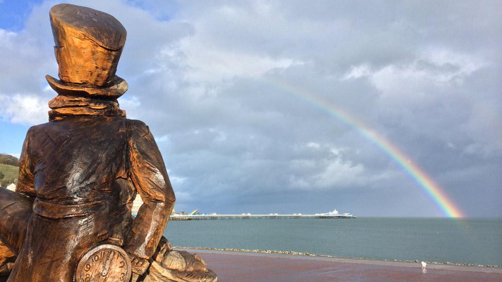 Mad Hatter statue, Llandudno pier and rainbow