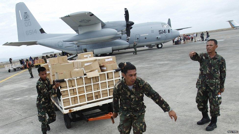 Military personnel deliver aid supplies at the destroyed airport in Tacloban City, in central Philippines