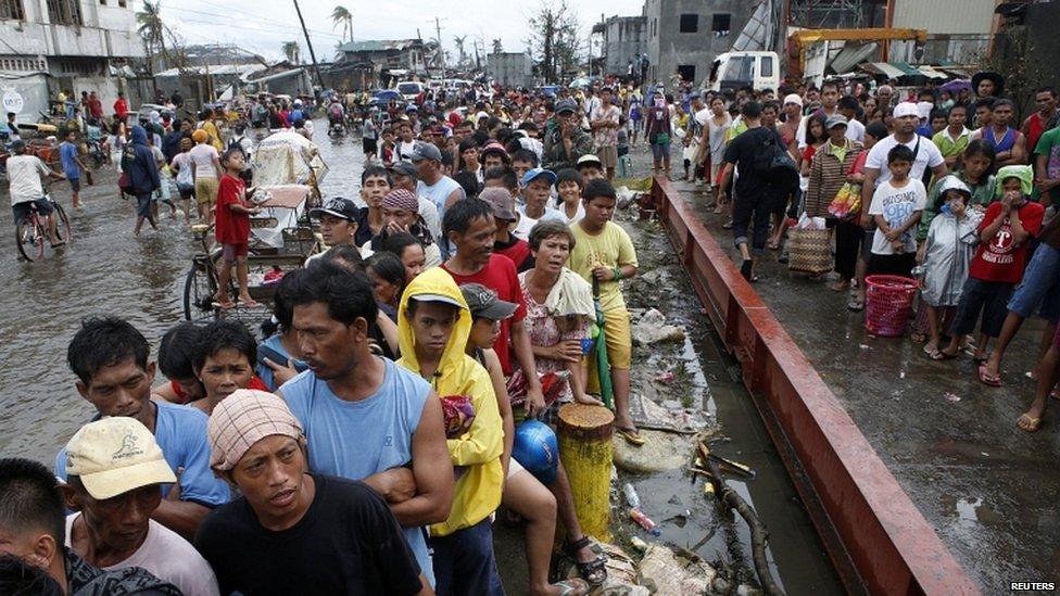 Typhoon victims queue for free rice at a businessman's warehouse in Tacloban city, which was battered by Typhoon Haiyan, in central Philippines