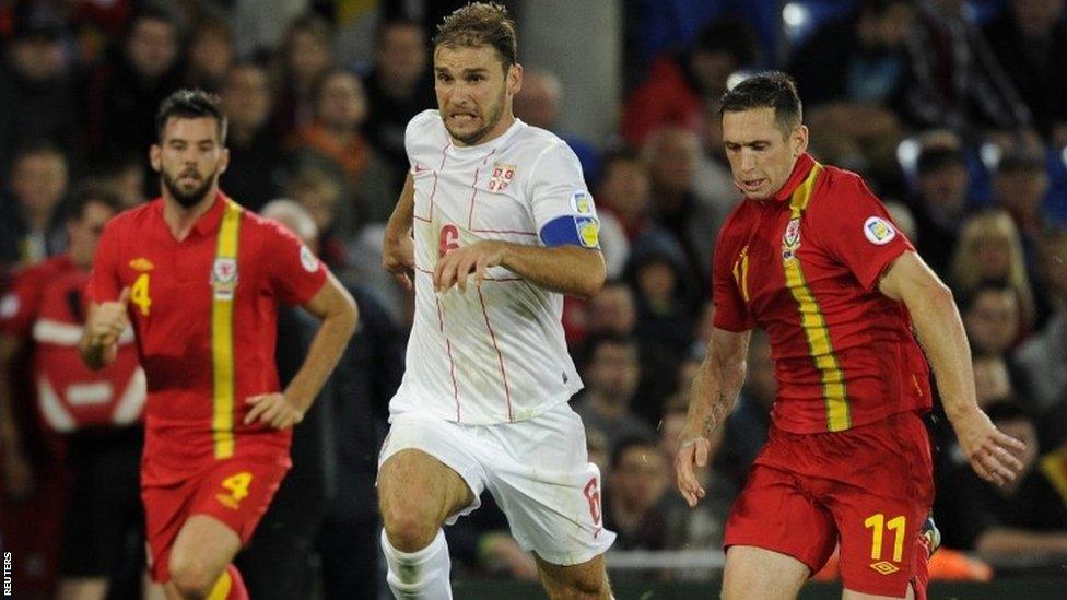 Wales' Andrew Crofts (right) fails to challenge Serbia's Branislav Ivanovic during their 2014 World Cup qualifying match at Cardiff City Stadium