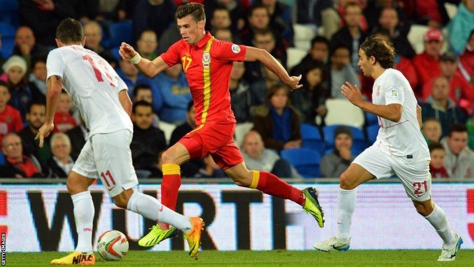 Wales' Gareth Bale (centre) runs with the ball against Serbia's Aleksandar Kolarov (left) and Lazar Markovic (right)