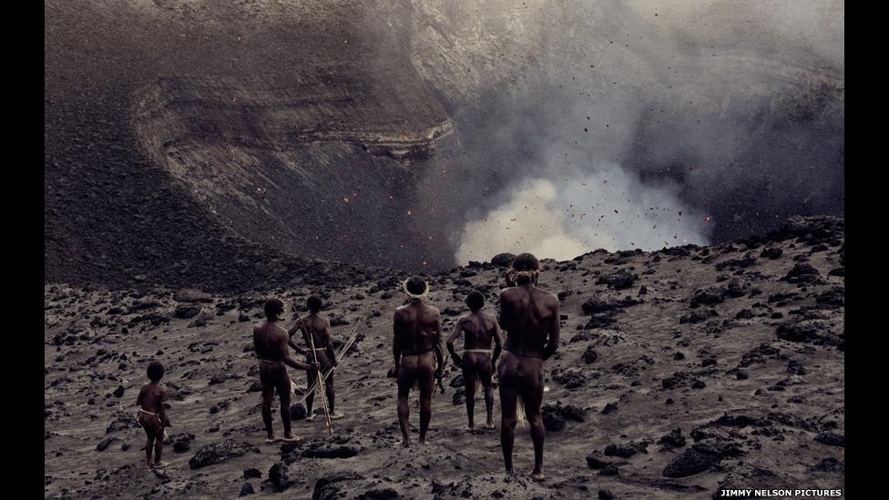 Ni-Vanuatus stand near an active volcano