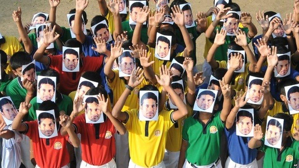 Students wear masks of Sachin Tendulkar in Nagpur, India, 13 November 2013