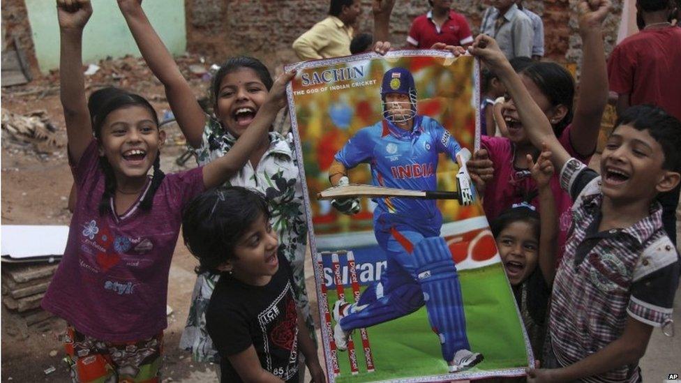 Tendulkar fans hold a poster of the cricketer in Hyderabad on 13 November 2013