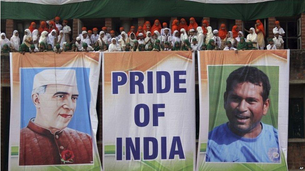 Students stand near giant banners showing Tendulkar and India's first prime minister Jawaharlal Nehru in the western city of Ahmedabad, 13 November 2013