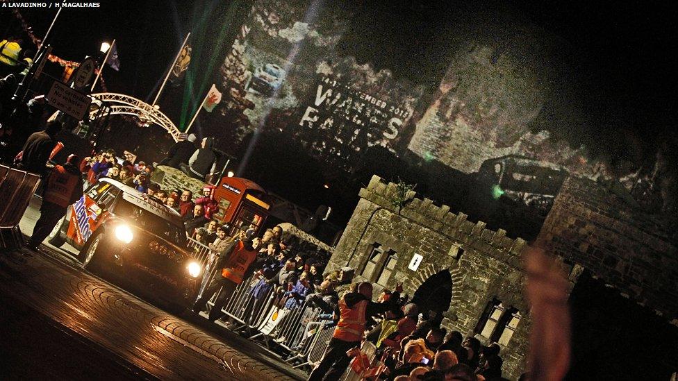 Crowds watch the ceremonial start of the Wales Rally GB in front of Conwy Castle