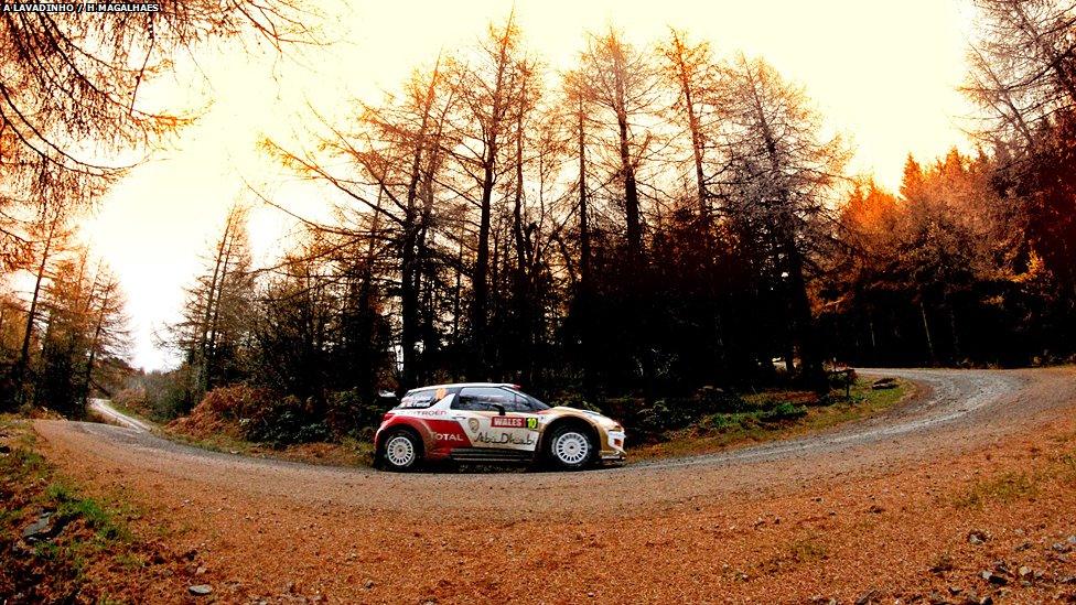 Rally car driving through a forest