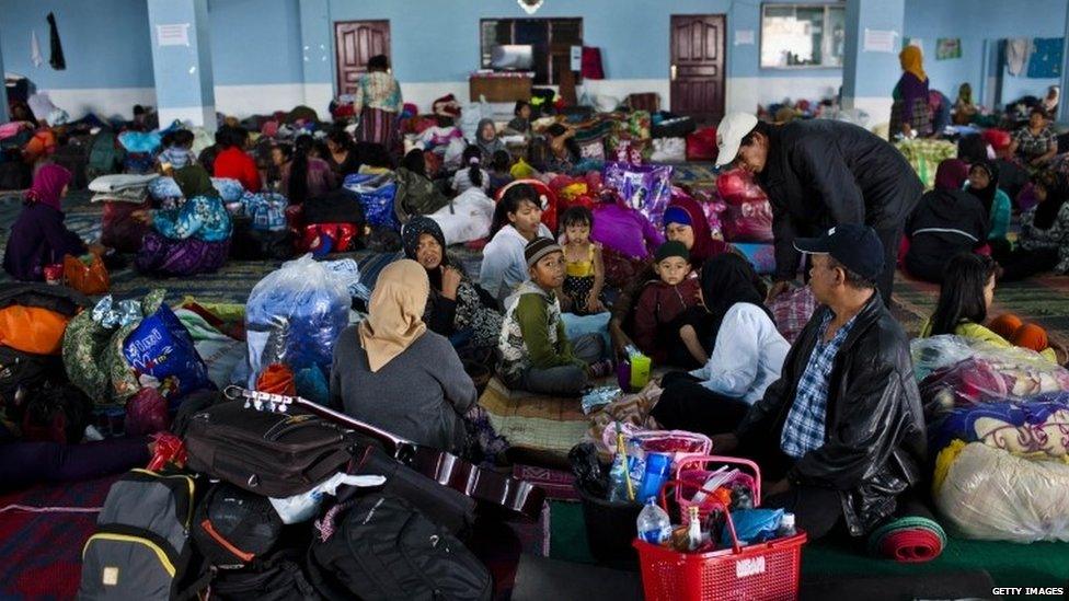 Refugees are seen at temporary evacuation centre following another eruption of Mount Sinabung in Karo district on 14 November 2013 in Medan, Sumatra, Indonesia