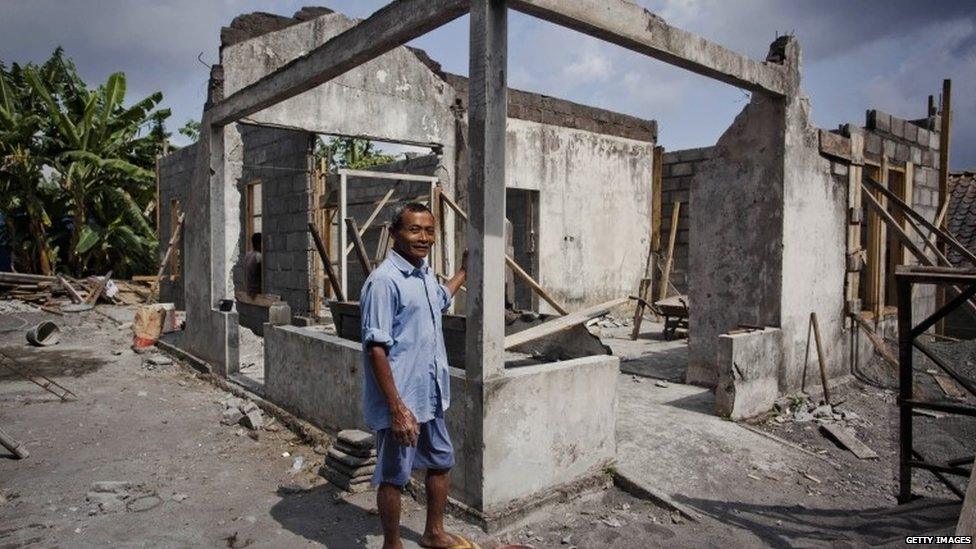 Gianto stands on front of his house destroyed by an eruption of Mount Merapi on 6 September 2013 in Yogyakarta, Indonesia