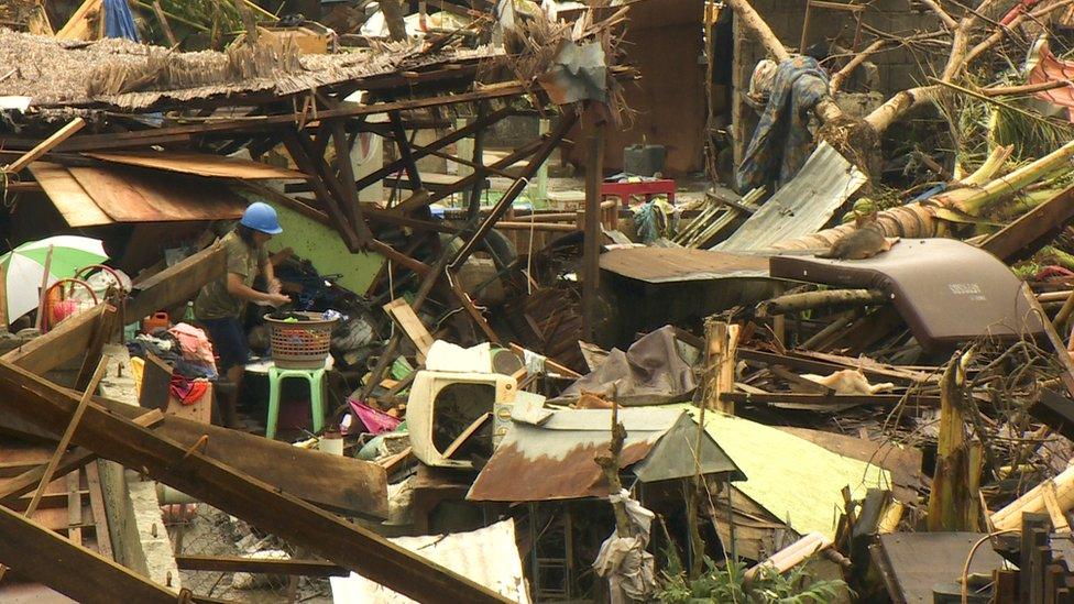 A woman doing her washing in Pawing, devastated by Typhoon Haiyan, in Leyte, central Philippines