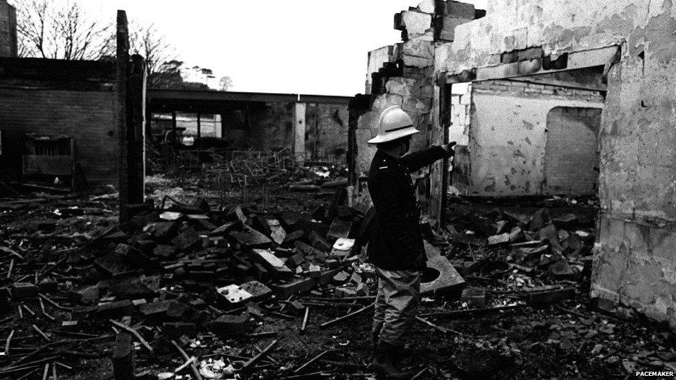 A fireman stands in the ruins of the La Mon Hotel