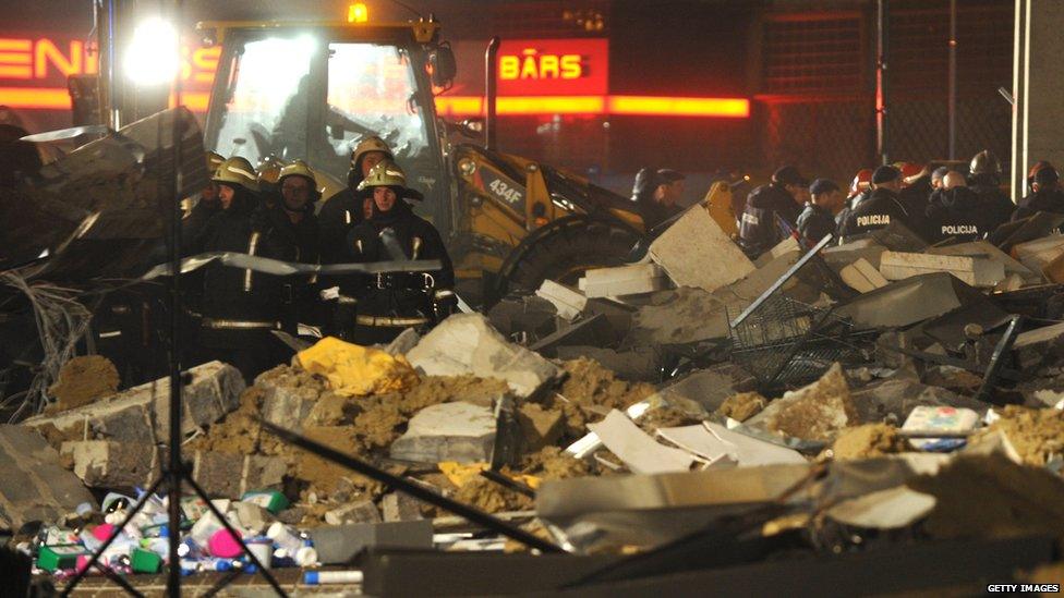 Rescuers search for survivors on 21 November 2013 in the rubble at the Maxima supermarket in Riga, after a roof collapsed.