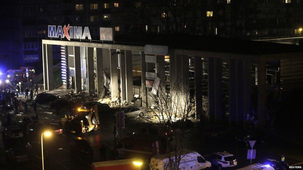 A general view shows a store with a collapsed roof in Riga