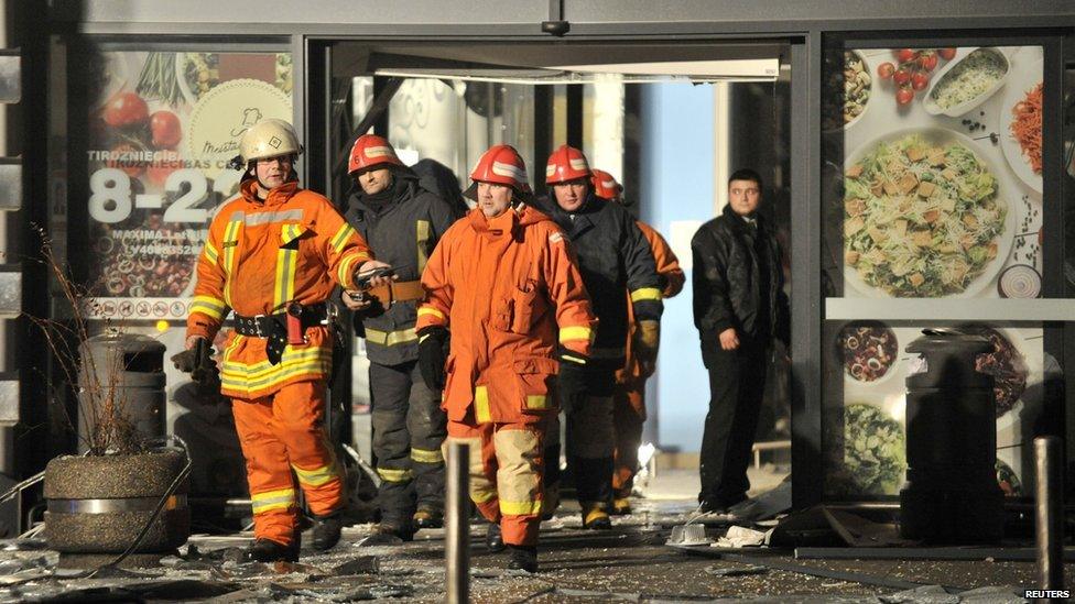 Rescuers work at the Maxima grocery store after its roof collapsed in Riga, Latvia, 21 November 2013