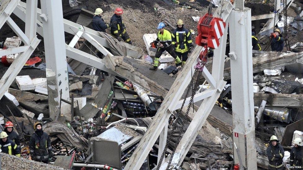 Rescue workers search debris of the Maxima supermarket in Riga, Latvia, Friday, Nov. 22, 2013