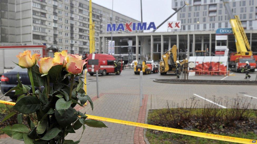 Flowers outside the collapsed Maxima supermarket in Riga, Latvia, Friday, Nov. 22, 2013