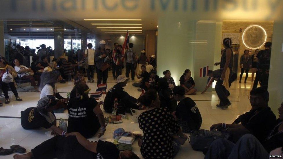 Anti-government protesters rest inside Thailand's Finance Ministry during a rally in central Bangkok 25 November 2013