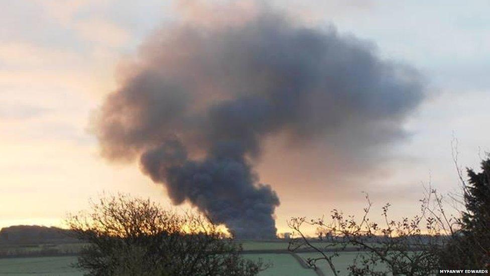 A huge plume of smoke can be seen from miles away