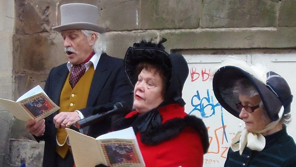 Carol-singers wearing hats