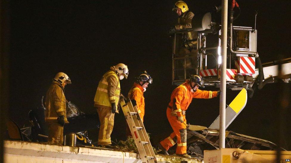 Rescue workers on Clutha roof alongside helicopter wreckage