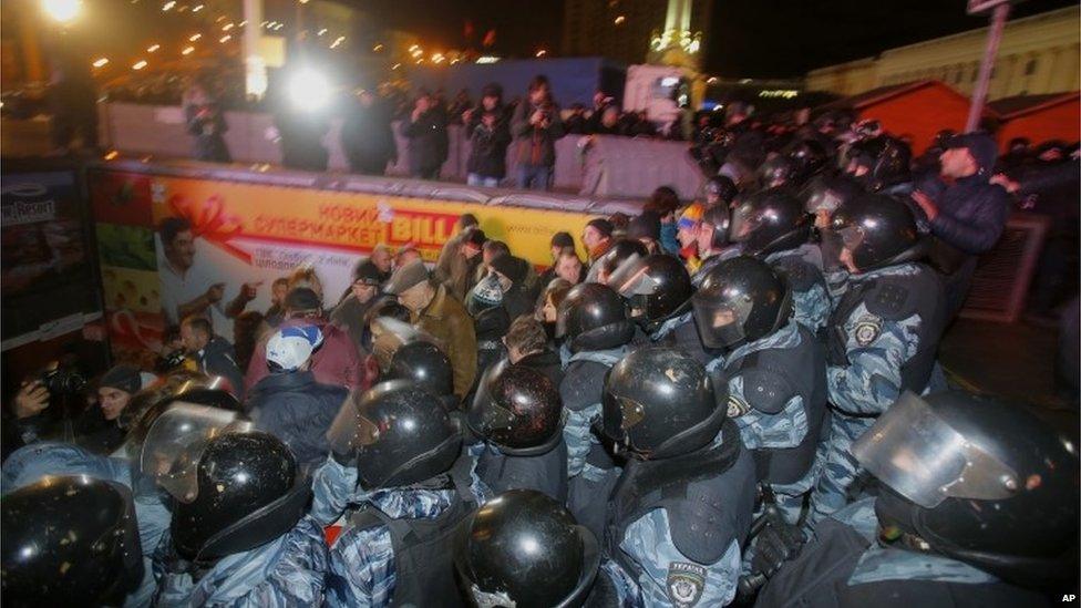 Police push protesters after dispersing them