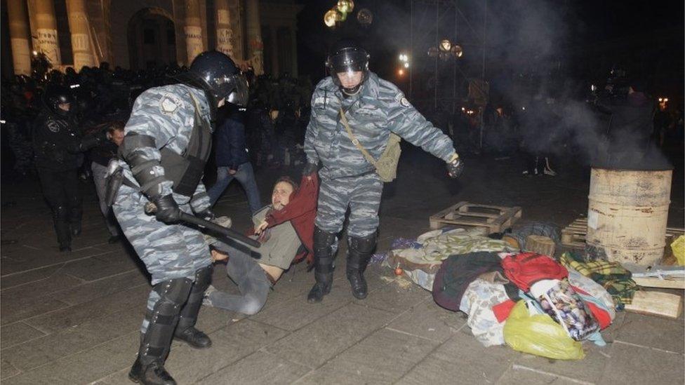 Police detain a protester