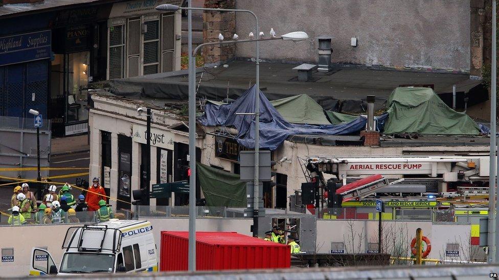 Emergency services at the Clutha Bar in Glasgow where a police helicopter crashed last night.