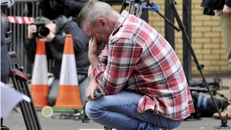 Paul Watt, a regular at the Clutha pub, reacts at the police cordon set up around the site of a helicopter crash on the Clutha in the centre of Glasgow