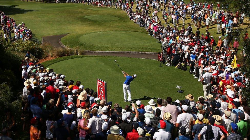 Rory McIlroy hits his drive at the 15th hole on his way to a closing round of 66 and a one-shot victory over world number two Adam Scott