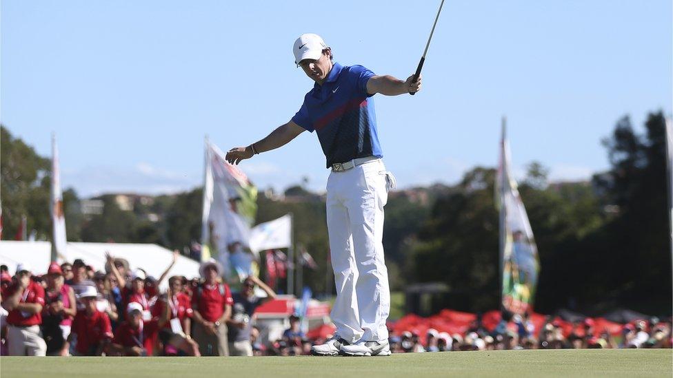 Rory McIlroy holes his birdie putt on the final green to secure a dramatic one-shot victory over Adam Scott at the Australian Open