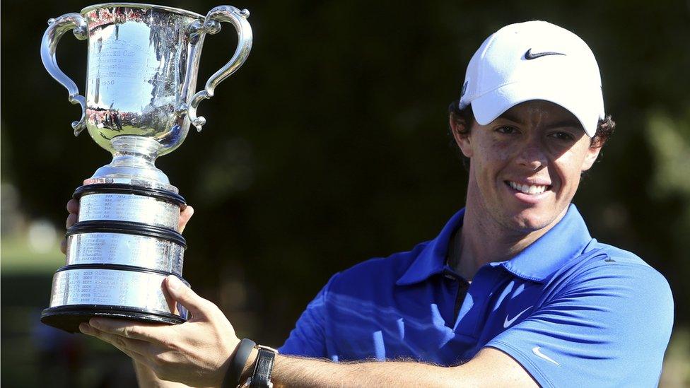 Northern Ireland's Rory McIlroy holds the trophy after his one-shot win over Masters champion Adam Scott at the Australian Open