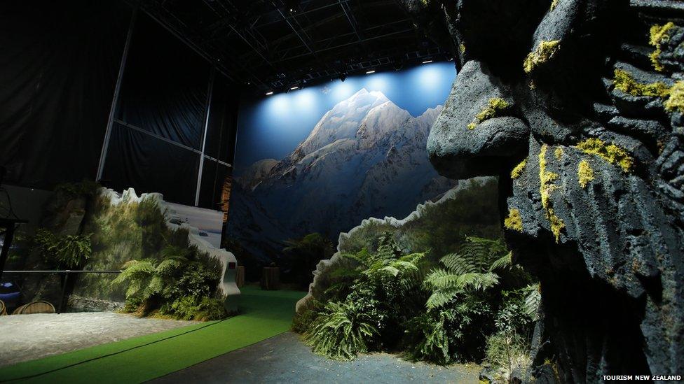 A giant pop-up book showing a mountain scene