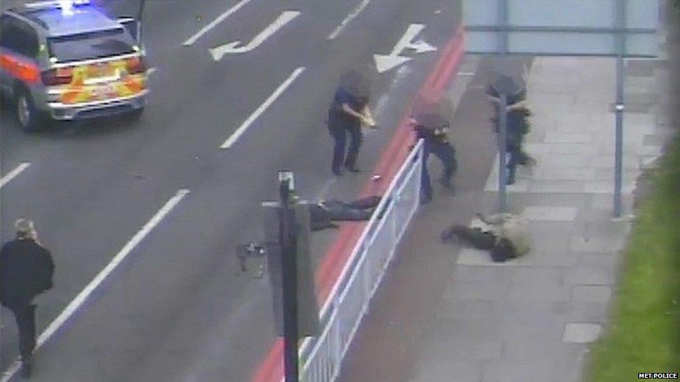 Michael Adebowale raising his gun, while on the ground