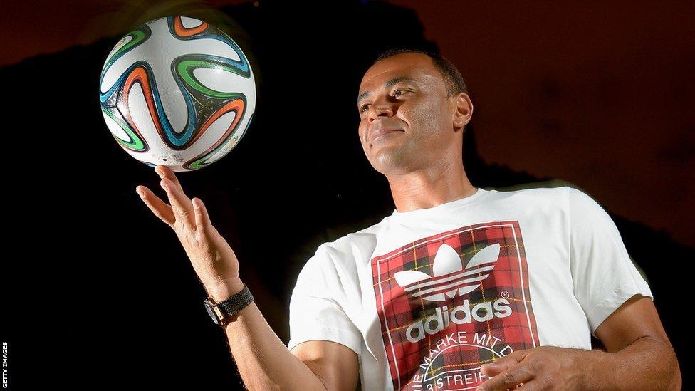 The Brazuca is being held by Brazil captain Cafu