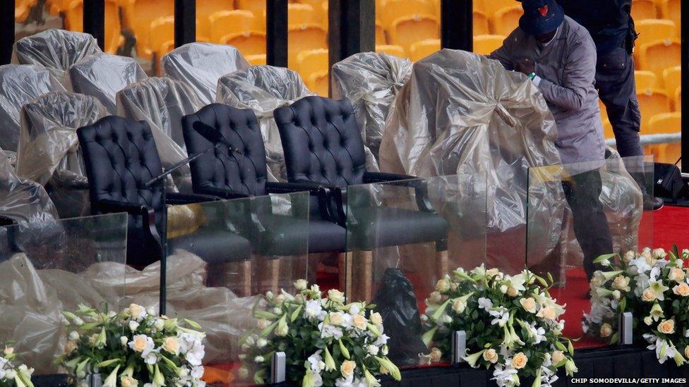 Plastic sheeting is removed from chairs on the main stage