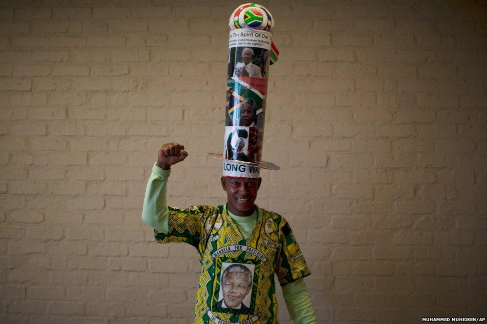 A mourner poses with his homemade hat