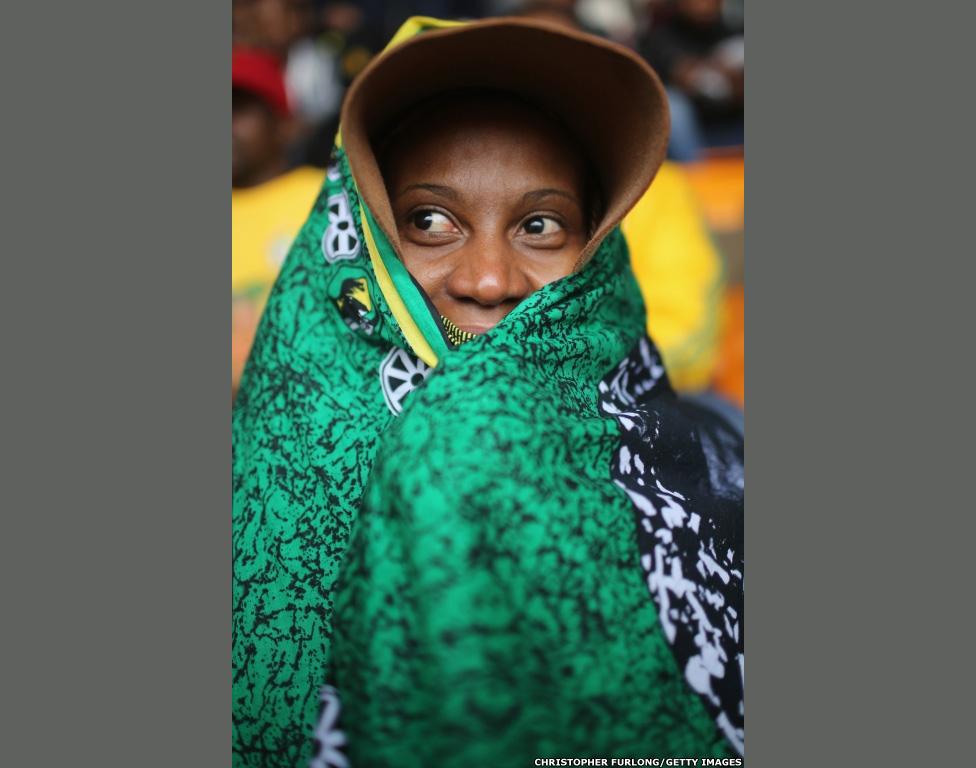 A woman waits for the Nelson Mandela memorial service