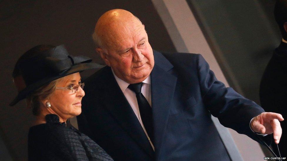 Former South African president FW De Klerk gestures as he arrives with his wife Elita