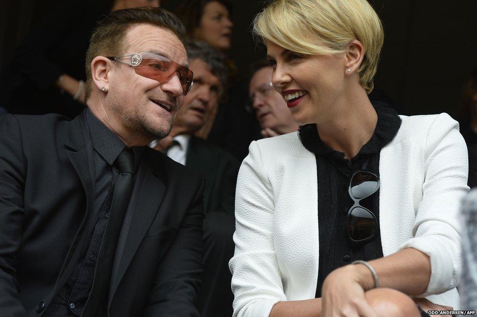 Irish band U2's lead singer Bono and South African actress Charlize Theron